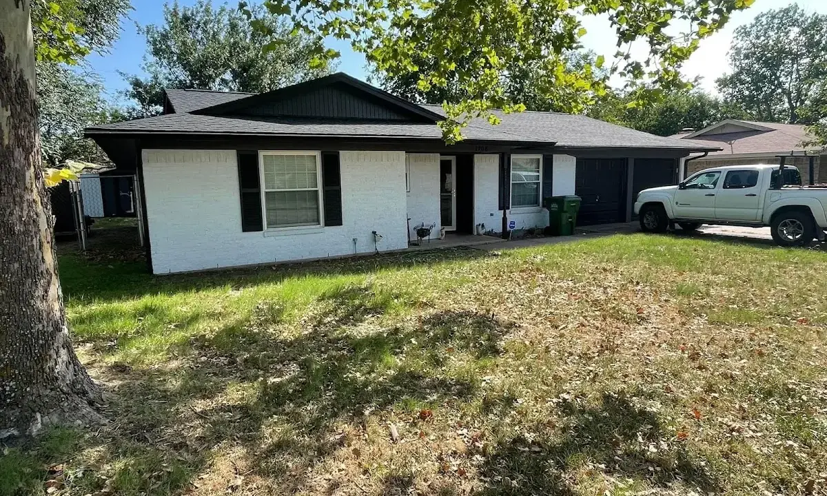 Professional roofing crew working on a residential roof in Larchmont